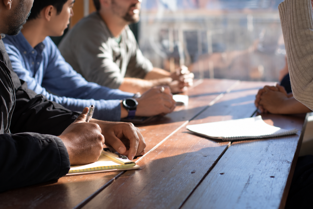 Professionals discussing plans at a sunlit table